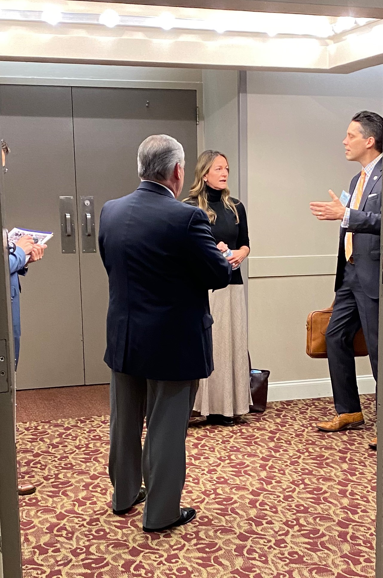 Dr. Brittany Birken talks with attendees after her presentation